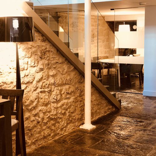 An office with a stone floor and stone walls.