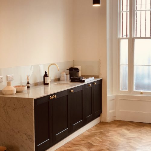 A warm room with counters and a sink.