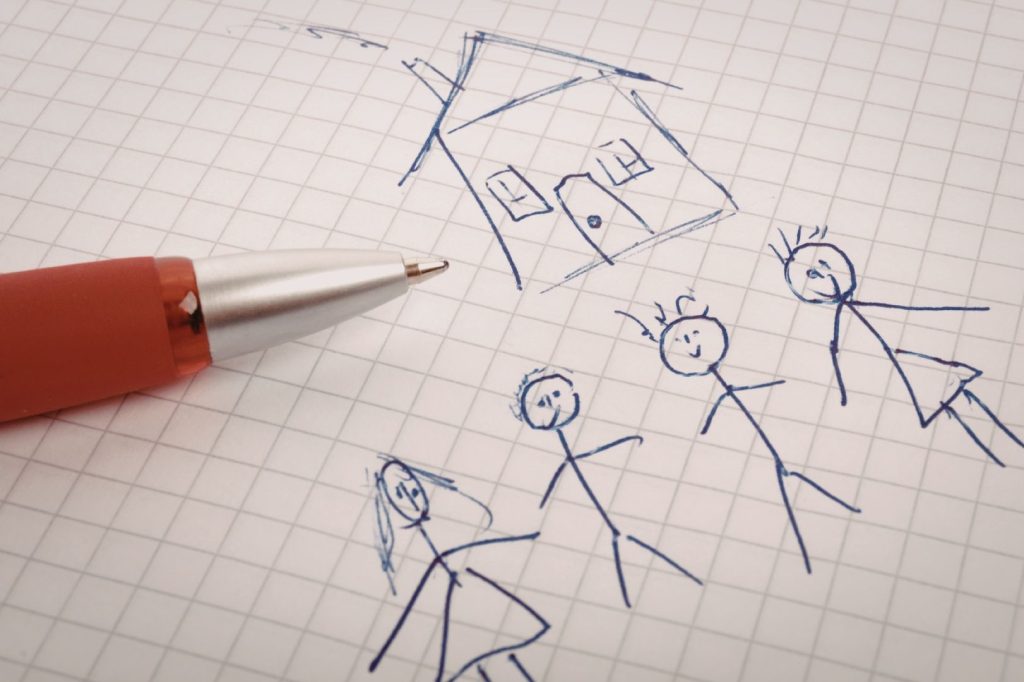 A child-drawn doodle of a house and four people.