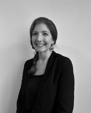A monochrome smiling middle-aged woman